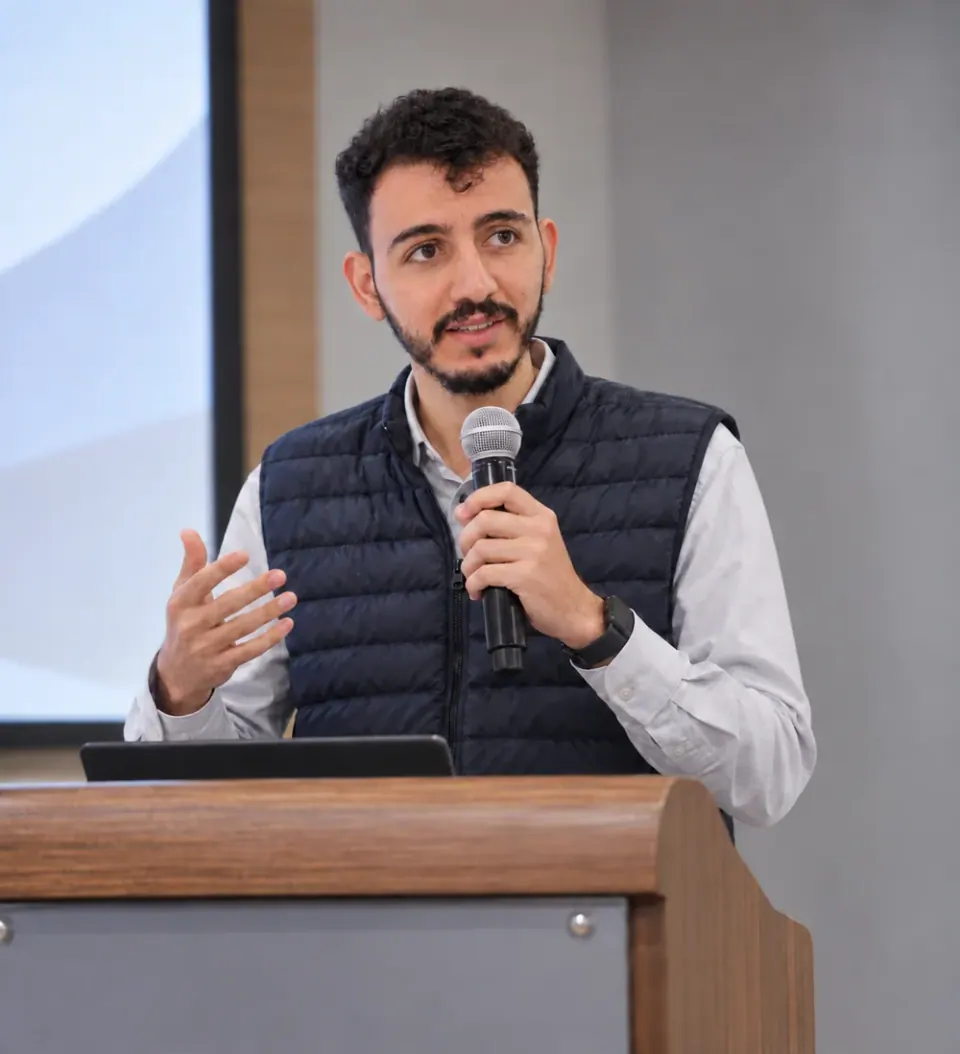Badissy Ayman speaking at a lectern